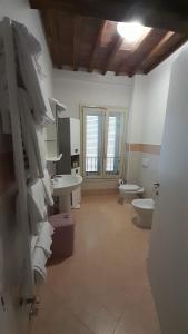 a bathroom with two toilets and a sink and a toilet paper dispenser at Appartamento Il Pozzo in Capannori