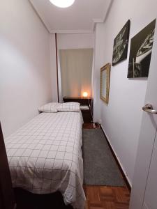 A bed or beds in a room at Hostal