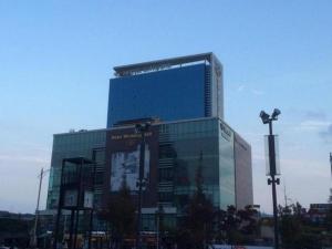 a large glass building with a sign on it at Hotel Sunshine in Daejeon