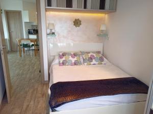 a small bedroom with a bed and a dining room at Apartamento Rosamar, sea view in Los Cristianos