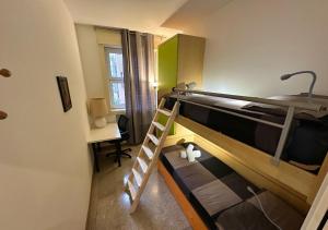 a small room with two bunk beds and a desk at Buenos Aires Urban Escape - [Metro & Self-Checkin] in Milan