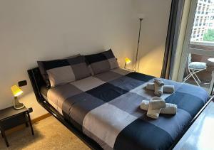 a bedroom with a bed with two teddy bears on it at Buenos Aires Urban Escape - [Metro & Self-Checkin] in Milan