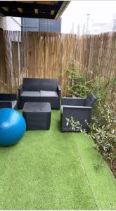 a patio with two couches and a blue ball at Appartement cosy et bien équipé in Nanterre