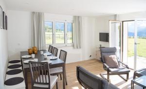 a living room with a dining room table and chairs at Ferienhaus mit Garten Tgease Schilendra-Lantsch-Lenz-Lenzerheide in Lenz