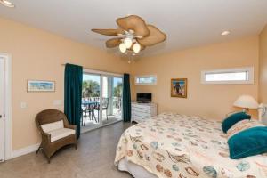 a bedroom with a bed and a ceiling fan at 102 6Th St S-Downstairs Home in Bradenton Beach