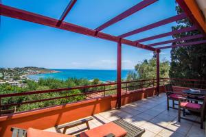 a balcony with a view of the ocean at Aeriko Benovias Rooms & Apartments in Karfas
