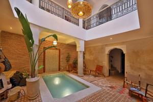 an indoor swimming pool in a house at Riad Al Badia in Marrakech