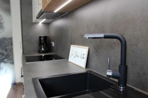 a kitchen counter with a sink and a faucet at Apart Panoramablick 