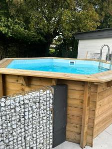 a swimming pool on top of a wooden building at Cosy@Beauty in Petit-Rechain