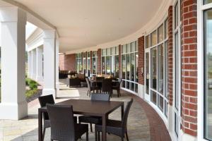 a patio with tables and chairs on a building at Courtyard by Marriott Youngstown Canfield in Canfield