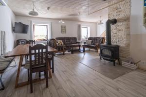 a living room with a fireplace and a wood stove at Žlutý dům - chalupa Krušné hory in Český Jiřetín