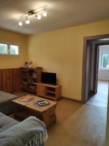 a living room with a couch and a table at La Ferme Du Levant in Gérardmer