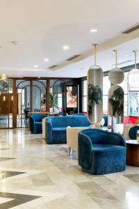 a lobby with blue couches and tables at Jaff Hotels & Spa Nisantasi in Istanbul