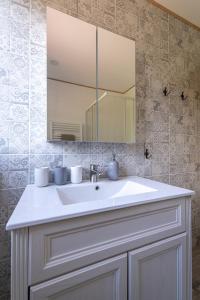 a bathroom with a white sink and a mirror at Žlutý dům - chalupa Krušné hory in Český Jiřetín