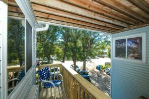 a porch with chairs and a view of a yard at Guld Drive House #54599 Home in Holmes Beach