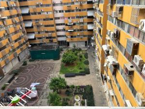 an aerial view of a courtyard between two buildings at Condo Poppular T8 fl.7 in Thung Si Kan