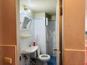 a bathroom with a toilet and a sink at Condo Poppular T8 fl.7 in Thung Si Kan