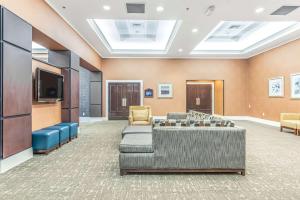a waiting room with couches and a flat screen tv at DoubleTree by Hilton Columbus in Columbus