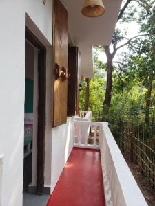 a walkway leading to a house with a red floor at Laxmi Happy Home in Querim Goa in Querim +37 photos
