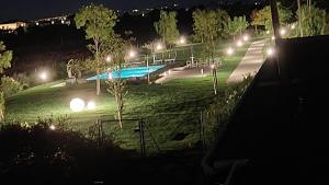 un parque nocturno con piscina y luces de calle en I Delfini - Natural B&B en Cesenatico