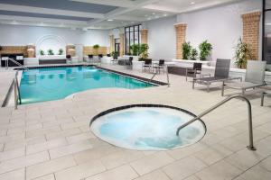 a hotel lobby with a large swimming pool at Embassy Suites by Hilton Orlando North in Orlando