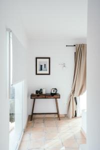 a living room with a table and a window at Hearts & Home in Mijas