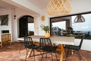 a dining room with a white table and chairs at Hearts & Home in Mijas