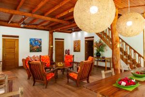 a dining room with a table and chairs at Anse Lazio Lodge in Anse Lazio