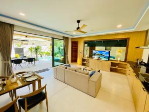 a living room with a couch and a dining room at Yuka residence in Koh Samui