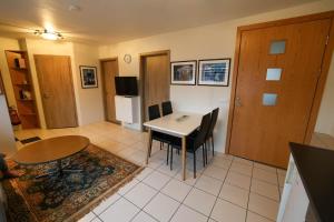 a kitchen and dining room with a table and chairs at Olga Apartments in Grundarfjordur