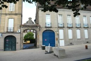 an old building with two blue doors in a street at T2 a Couvent Des Cordeliers in Autun