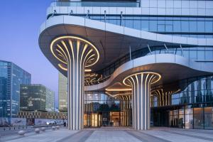 a large building with two columns in front of it at Hilton Garden Inn Zibo Zhangdian in Zibo