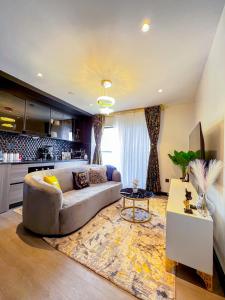 a living room with a couch and a table at Escada Next level luxurious 1 bed home in Nairobi