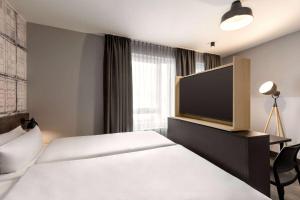 Cama o camas de una habitación en Vienna House Easy by Wyndham Bremen City Apartments