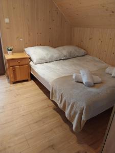 a bedroom with a bed with two towels on it at Relaksówka 