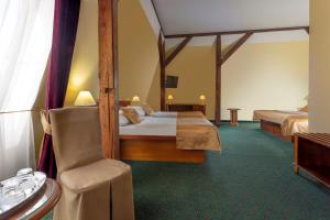 a hotel room with two beds and a chair at Hotel William in Prague +36 photos