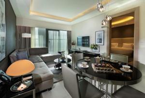 a living room with a couch and a table at PARAMOUNT Hots & residential property in Dubai