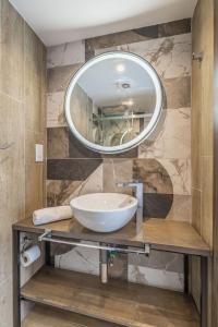 a bathroom with a sink and a mirror at Studio 31 with kitchenette at the new Olo living in Paceville