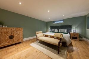 a bedroom with a bed and a chair in it at 58D Earlham Road in Norwich