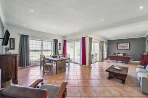 a living room with a couch and a table at Seaside Villa - 1 La Mer in Hout Bay