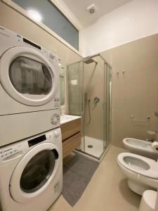 een wasmachine in een badkamer met een toilet bij Aversa Exclusive private room in Aversa