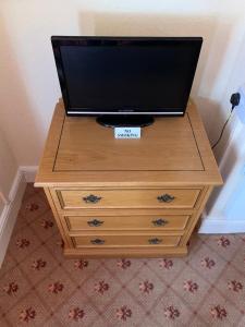 a television on top of a wooden dresser at The Redcliffe Hotel in Scarborough