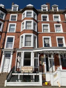 a large brick building with a sign on it at The Redcliffe Hotel in Scarborough