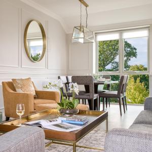 a living room with a table and chairs at The Lodges at Glenlo Abbey Hotel and Estate in Galway