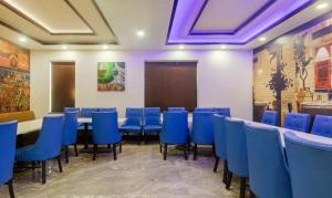 a conference room with blue chairs and a table at Treebo Trend The Royal Taj 3900 m from Taj Mahal Agra in Agra