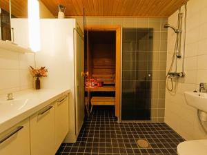 a bathroom with a shower and a sink and a toilet at Näköalahuoneisto 324 in Syöte +16 photos