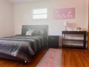 a bedroom with a bed with a rug and a table at Cozy 2 Bedroom in Cleveland in Cleveland Heights
