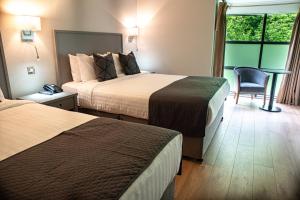 A bed or beds in a room at Arklow Bay Hotel
