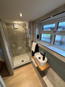 a bathroom with a sink and a shower at Rylands Farm Guest House in Wilmslow