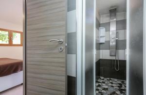 a shower with a glass door in a bathroom at Village Camping Santa Fortunata - Campogaio in Sorrento